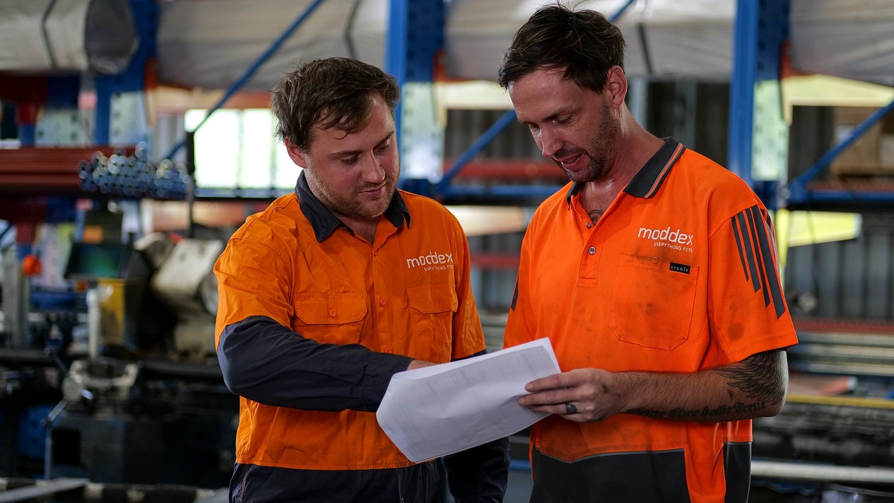 Moddex handrail and balustrade manufacturing production team members looking at plans