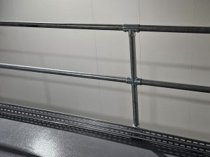 Moddex Tuffrail TR25 industrial handrails with Tuffgard Toeboard on a service platform mezzanine at a Woolworths customer fulfilment centre warehouse