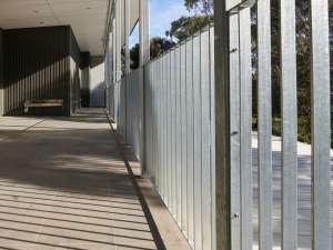 Galvanised Moddex FlatBal flat bar balustrades installed along an elevated external walkway at a school, delivering durable edge protection with a clean architectural finish.