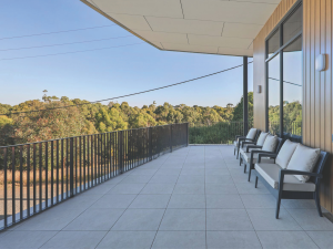 Powder-coated Moddex FlatBal flat bar balustrades installed on an elevated balcony, combining modern architectural styling with compliant fall protection and uninterrupted views.