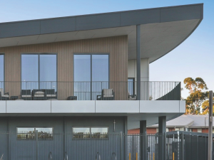 Powder-coated flat bar balustrades installed on an aged care facility balcony, delivering compliant fall protection with a modern architectural finish.