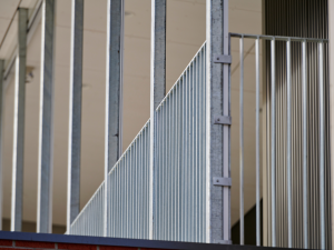 Galvanised FlatBal flat bar balustrade barriers installed along an elevated building edge, providing compliant fall protection with a clean architectural appearance.